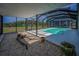 Enclosed pool area with ample space, providing a refreshing retreat and beautiful views at 1616 Sea Breeze Dr, Tarpon Springs, FL 34689