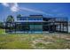 Exterior view of a screened-in pool area, offering privacy and protection for year-round enjoyment at 1616 Sea Breeze Dr, Tarpon Springs, FL 34689