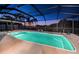 Inviting screened-in pool offers a refreshing escape with palm tree views and a tranquil ambiance at 1616 Sea Breeze Dr, Tarpon Springs, FL 34689
