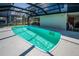 Backyard view of the screened-in pool, seamlessly connected to the patio and entertainment areas at 1616 Sea Breeze Dr, Tarpon Springs, FL 34689