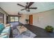 Spacious lanai featuring dual fans, access door, and a cozy seating area at 1616 Sea Breeze Dr, Tarpon Springs, FL 34689