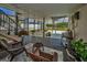 Inviting covered porch with comfortable seating and serene garden view at 1616 Sea Breeze Dr, Tarpon Springs, FL 34689