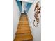 Stylish staircase features wood and tile steps accented by coastal décor and a crisp white handrail at 1616 Sea Breeze Dr, Tarpon Springs, FL 34689