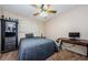 Simple bedroom features a ceiling fan, window with blinds, and a desk with a modern computer setup at 2261 Swedish Dr # 33&35, Clearwater, FL 33763