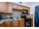 Contemporary kitchen boasts tiled countertops and backsplash, wood cabinets, and modern appliances at 2261 Swedish Dr # 33&35, Clearwater, FL 33763