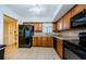 Well-equipped kitchen with wood cabinets and black appliances, spacious and functional at 2261 Swedish Dr # 33&35, Clearwater, FL 33763