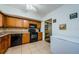 This kitchen features wood cabinets, black appliances, tile floors and backsplash at 2261 Swedish Dr # 33&35, Clearwater, FL 33763