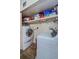 Bright laundry room featuring a stacked washer and dryer and built in storage at 2261 Swedish Dr # 33&35, Clearwater, FL 33763