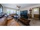 Spacious living room with bright natural light, plush leather sofas, and ceiling fan at 2261 Swedish Dr # 33&35, Clearwater, FL 33763