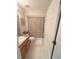 Bathroom with a vanity, toilet, shower with curtain, and neutral tile floors at 2931 Walnut Grove Ct, Holiday, FL 34691