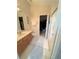 Bright bathroom featuring a walk-in closet, a walk-in shower, and a single sink at 2931 Walnut Grove Ct, Holiday, FL 34691