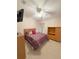 Comfortable bedroom featuring neutral carpeting and a ceiling fan with a light fixture at 2931 Walnut Grove Ct, Holiday, FL 34691