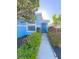 Charming home exterior with a well-maintained front yard, blue paint, and inviting walkway to the front door at 2931 Walnut Grove Ct, Holiday, FL 34691