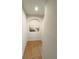 Hallway featuring wood floors and an alcove with art, creating an inviting transition space at 2931 Walnut Grove Ct, Holiday, FL 34691