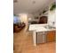 Open-concept living space with laminate floors, plenty of light, and a view of the kitchen at 2931 Walnut Grove Ct, Holiday, FL 34691