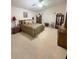 Cozy bedroom featuring neutral carpet, furniture, a ceiling fan, and lots of natural light at 2931 Walnut Grove Ct, Holiday, FL 34691
