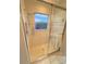 Modern bathroom shower stall with glass doors and a window, offering a refreshing space at 2931 Walnut Grove Ct, Holiday, FL 34691