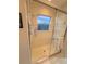 Bathroom shower stall, featuring glass doors, a small window and tiled walls at 2931 Walnut Grove Ct, Holiday, FL 34691