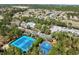 Aerial view of the community with multiple amenities, pool, tennis court, and trees at 3667 Autumn Amber Dr, Spring Hill, FL 34609