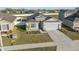 Aerial view of a well-kept home, showcasing the landscaped yard and convenient two-car garage at 3667 Autumn Amber Dr, Spring Hill, FL 34609
