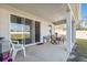 Covered back patio with a patio table and chairs, perfect for outdoor dining at 3667 Autumn Amber Dr, Spring Hill, FL 34609