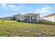 Spacious backyard with a covered patio, perfect for outdoor entertaining at 3667 Autumn Amber Dr, Spring Hill, FL 34609