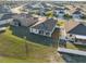 Aerial view of backyard with a covered patio, green lawn, privacy fence, perfect for entertaining and relaxing at 3667 Autumn Amber Dr, Spring Hill, FL 34609