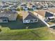 The spacious backyard has a covered patio, green lawn, and white vinyl fence for privacy and outdoor enjoyment at 3667 Autumn Amber Dr, Spring Hill, FL 34609