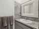Updated half bath with a granite countertop, decorative backsplash, and tiled floors at 3667 Autumn Amber Dr, Spring Hill, FL 34609