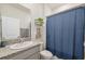 Cozy bathroom featuring a granite countertop and decorative blue shower curtain at 3667 Autumn Amber Dr, Spring Hill, FL 34609