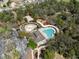 Aerial view showcasing community amenities, with a pool, splash pad, clubhouse, volleyball court, and playground at 3667 Autumn Amber Dr, Spring Hill, FL 34609