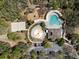 Aerial view of community amenities: pool, splashpad, volleyball court, playground, clubhouse, and parking at 3667 Autumn Amber Dr, Spring Hill, FL 34609