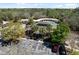 Aerial view of a community center with a pool, lounge chairs, palm trees and ample parking at 3667 Autumn Amber Dr, Spring Hill, FL 34609