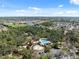 Aerial view of a community pool with a playground and splash pad surrounded by trees and homes at 3667 Autumn Amber Dr, Spring Hill, FL 34609