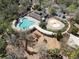 Aerial view of a community pool with a playground and splash pad surrounded by trees at 3667 Autumn Amber Dr, Spring Hill, FL 34609