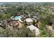 Aerial view of a community pool with a playground and splash pad surrounded by trees at 3667 Autumn Amber Dr, Spring Hill, FL 34609