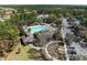 Aerial view of the neighborhood pool and amenity center surrounded by mature trees at 3667 Autumn Amber Dr, Spring Hill, FL 34609