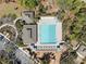 Aerial view of a community pool with lounge chairs, cabanas, playground and parking at 3667 Autumn Amber Dr, Spring Hill, FL 34609
