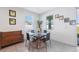 Bright dining area featuring modern decor, large windows, and a stylish glass table perfect for Gathering meals at 3667 Autumn Amber Dr, Spring Hill, FL 34609