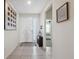 Bright entryway featuring tile flooring, neutral decor, and a view into the adjacent bedroom at 3667 Autumn Amber Dr, Spring Hill, FL 34609