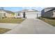 Attractive one-story home with a two-car garage, manicured lawn and landscape, and inviting facade at 3667 Autumn Amber Dr, Spring Hill, FL 34609