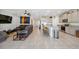 Bright living room featuring a large leather couch, colorful wall art, and an open floor plan leading to the kitchen at 3667 Autumn Amber Dr, Spring Hill, FL 34609