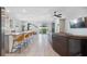 Open-concept living space with a kitchen island, modern barstools, and a seamless connection to the outdoors at 3667 Autumn Amber Dr, Spring Hill, FL 34609