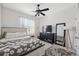Bright main bedroom with a ceiling fan, large dresser and mirror at 3667 Autumn Amber Dr, Spring Hill, FL 34609