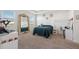 Serene primary bedroom with large windows, tray ceilings, and carpet flooring, offering a peaceful retreat at 3667 Autumn Amber Dr, Spring Hill, FL 34609