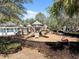 Community playground with slides and climbing structures on a mulch surface, fenced for safety at 3667 Autumn Amber Dr, Spring Hill, FL 34609
