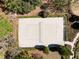 Aerial view of a sand volleyball court surrounded by trees and landscaping at 3667 Autumn Amber Dr, Spring Hill, FL 34609