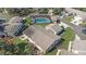 Aerial view of home featuring a screened pool and lush landscaping at 3806 River Oaks Ct, New Port Richey, FL 34655