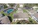 Aerial view of single Gathering home with pool; patio table with seating and landscaping at 3806 River Oaks Ct, New Port Richey, FL 34655