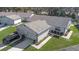 Aerial view of a well-maintained home with a two-car garage, neat landscaping, and an expansive roof at 3806 River Oaks Ct, New Port Richey, FL 34655